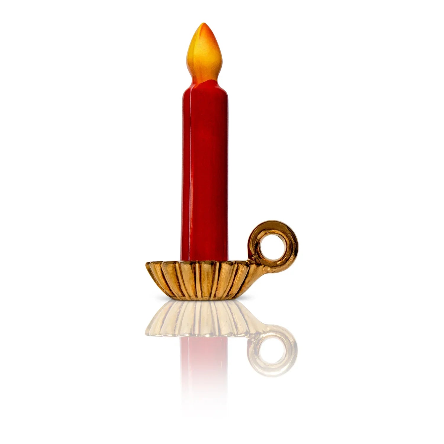 Nora Fleming Light The Way Mini decor item. A red candle with an orange burning flame that sits in a gold holder.