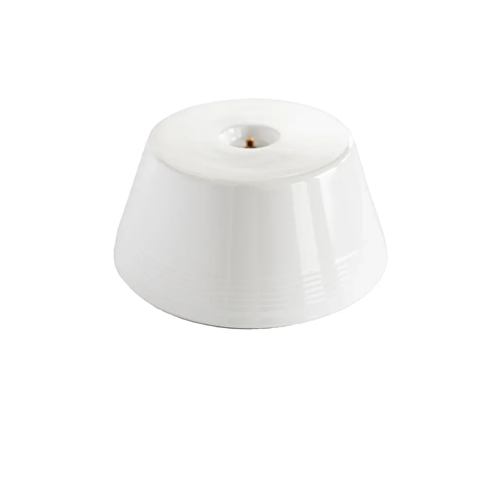 A white colored low riser stand made from Melamine by Nora Fleming.