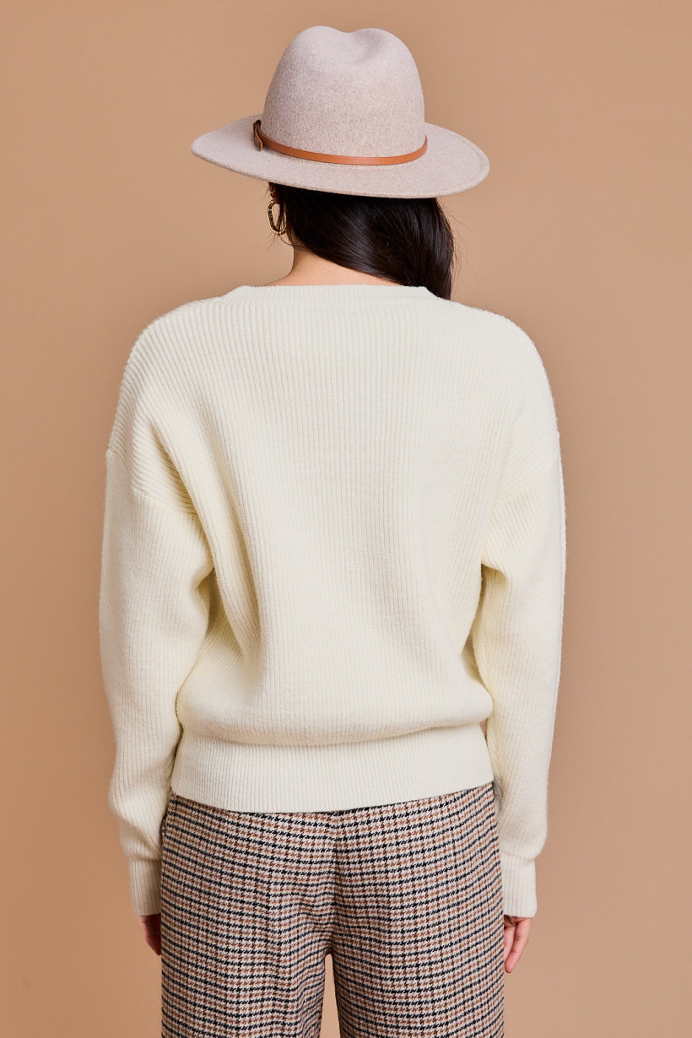 White pullover sweater with orange pumpkins across the front.