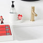 Towel holder displayed by a sink with a Christmas elf displayed on top