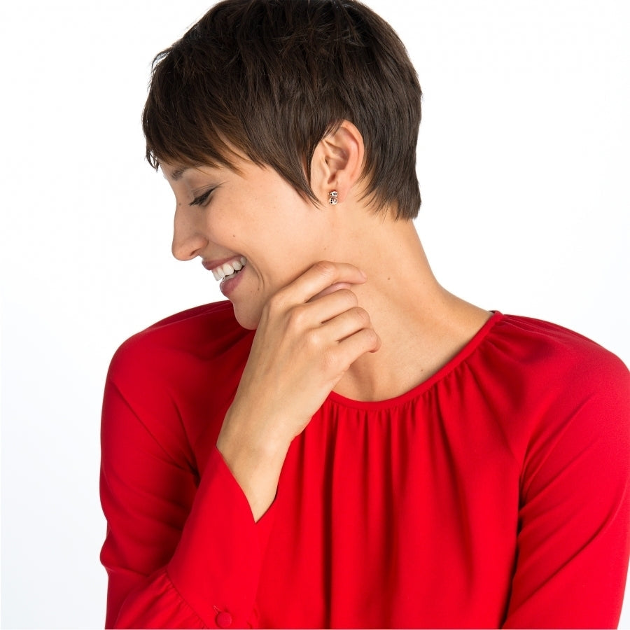 A smiling model wearing a red shirt, showing the snowman earrings on her left ear.