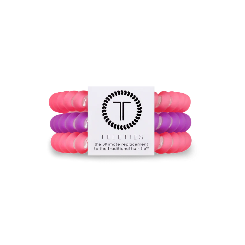 A pack of three small women's hair ties. Two color pink, one color purple. From TELETIES.
