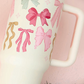 The Darling Effect 40 oz Take Me Everywhere Tumbler in cream with multi colored Christmas bows, and The Darling Effect logo.