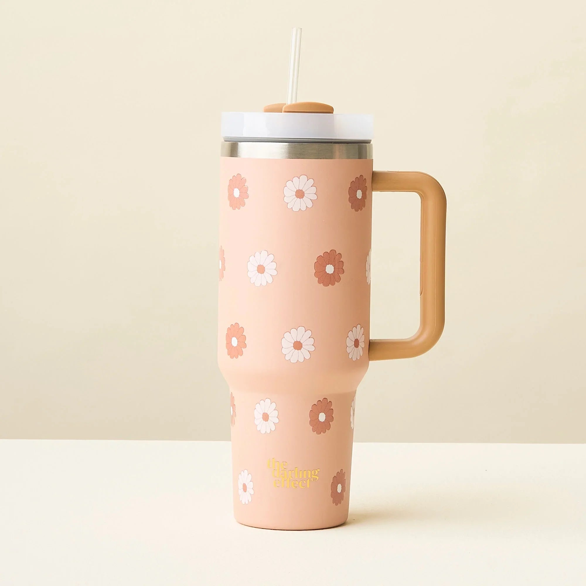 The Darling Effect 40 oz Take Me Everywhere Tumbler in color tan, with brown and white flowers, and a gold The Darling Effect logo.