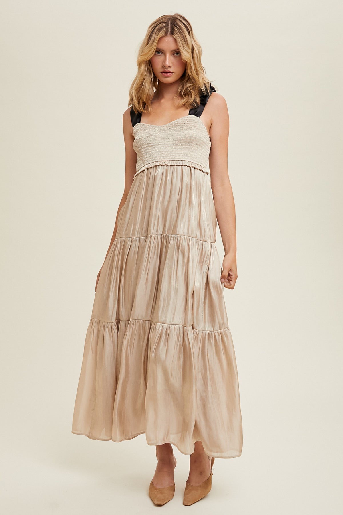 Tiered satin tie-strap maxi dress featuring a smocked bodice, side pockets, and an inside lining.