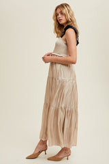 Tiered satin tie-strap maxi dress featuring a smocked bodice, side pockets, and an inside lining.