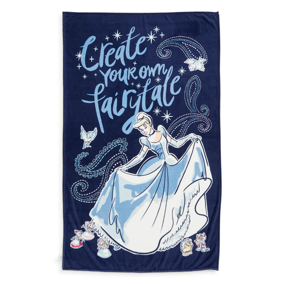 A blue plush throw blanket designed by Vera Bradley. It reads, "Create your own fairytale" and features Disney's Cinderella.