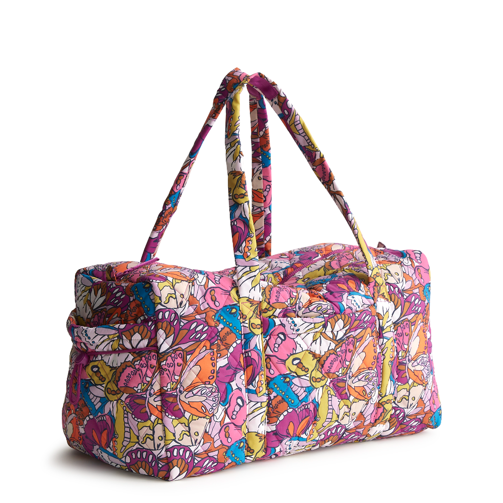 A large duffel bag designed by Vera Bradley in the colors pink, yellow, and blue. The bag is designed with nylon fabric.