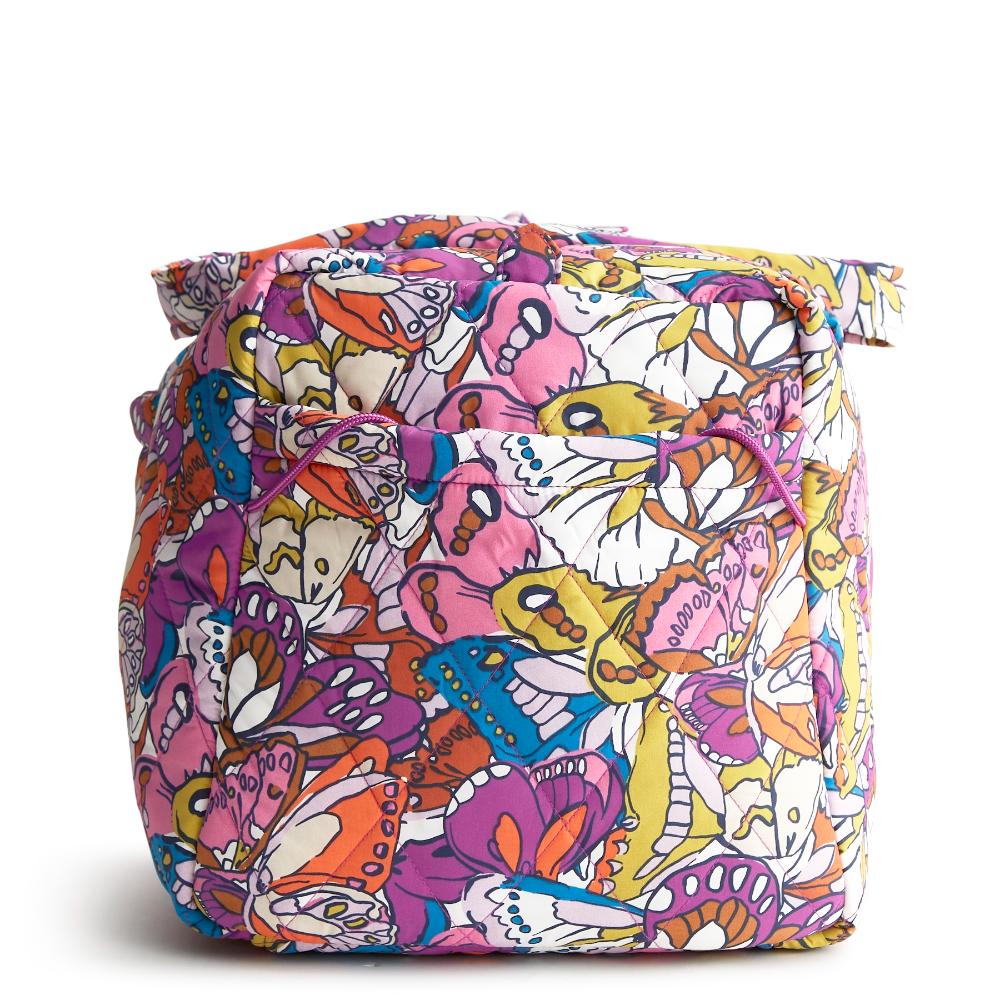 A large duffel bag designed by Vera Bradley in the colors pink, yellow, and blue. The bag is designed with nylon fabric.