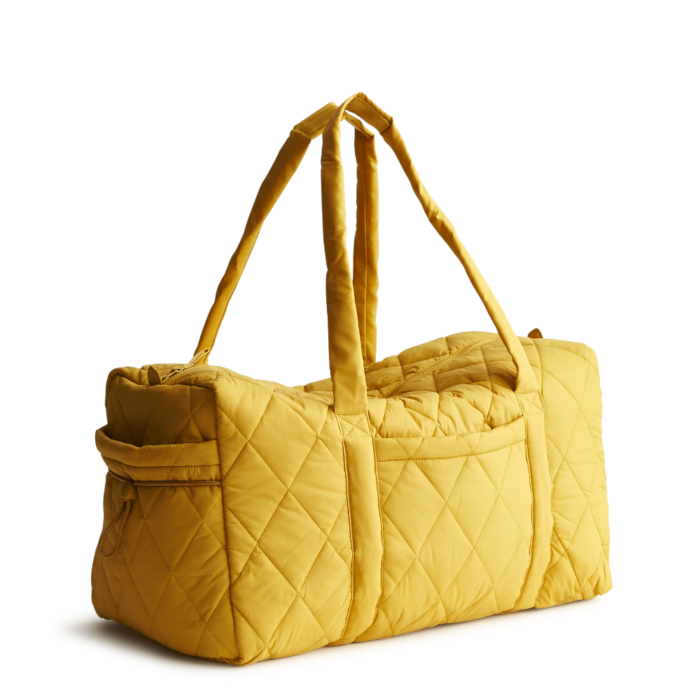 A large duffel bag designed by Vera Bradley in the color Nylon Golden Olive. The bag is designed with nylon fabric.