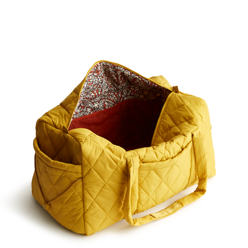 A large duffel bag designed by Vera Bradley in the color Nylon Golden Olive. The bag is designed with nylon fabric.