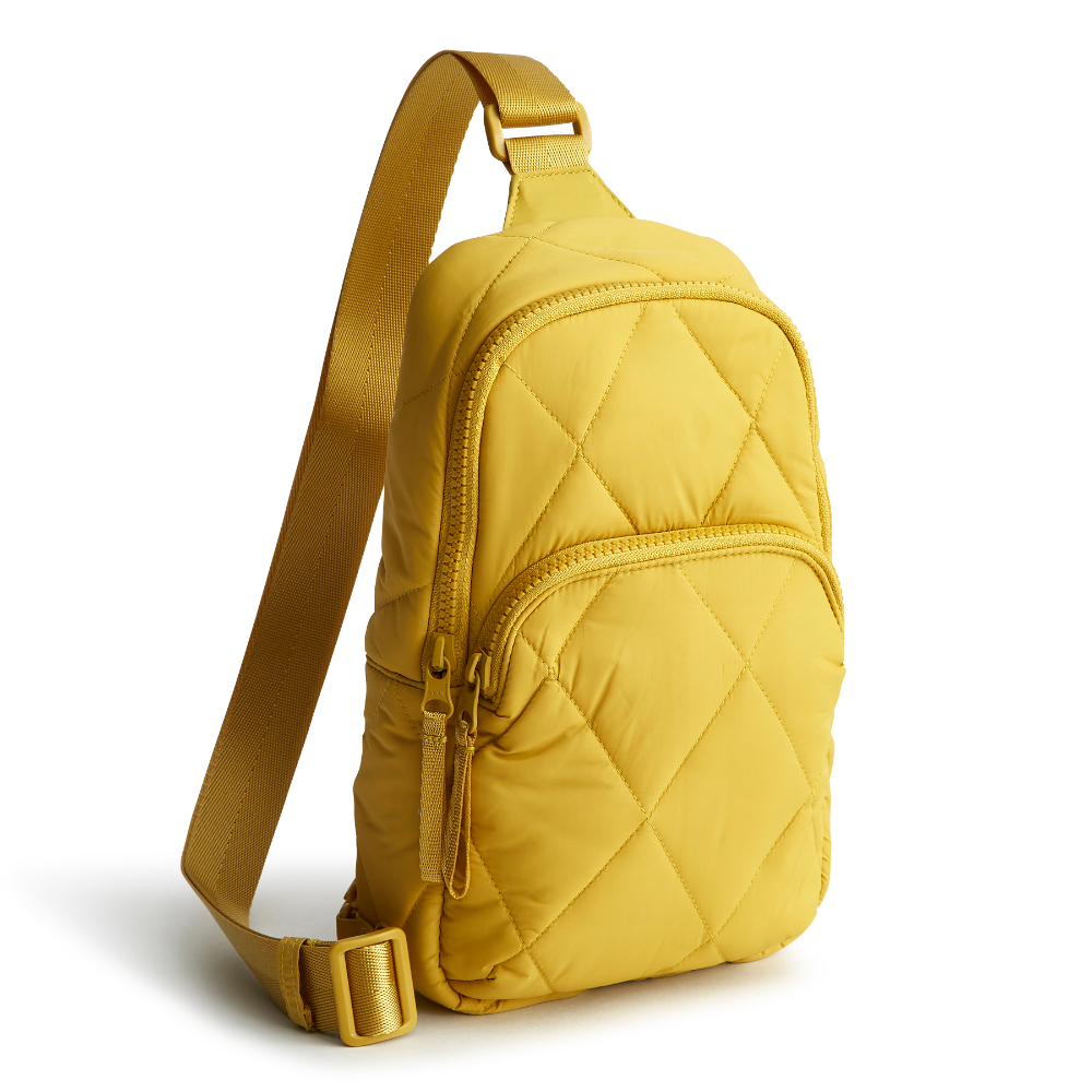 A Vera Bradley sling backpack in Golden Olive.