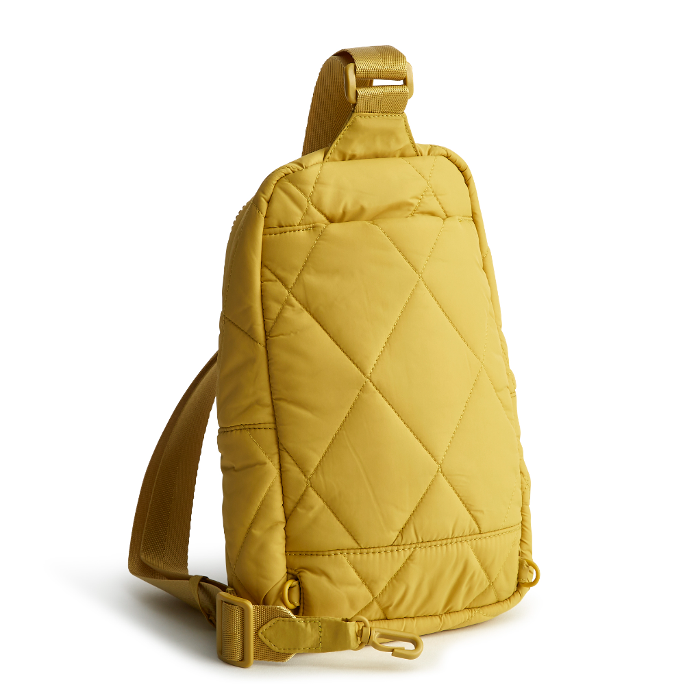 A Vera Bradley sling backpack in Golden Olive.