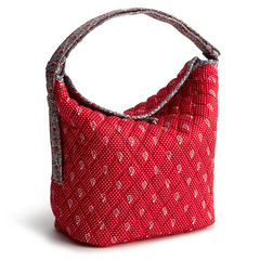 A red shoulder bag from Vera Bradley in the New Day Vera Bradley Dotty Floral Pattern.