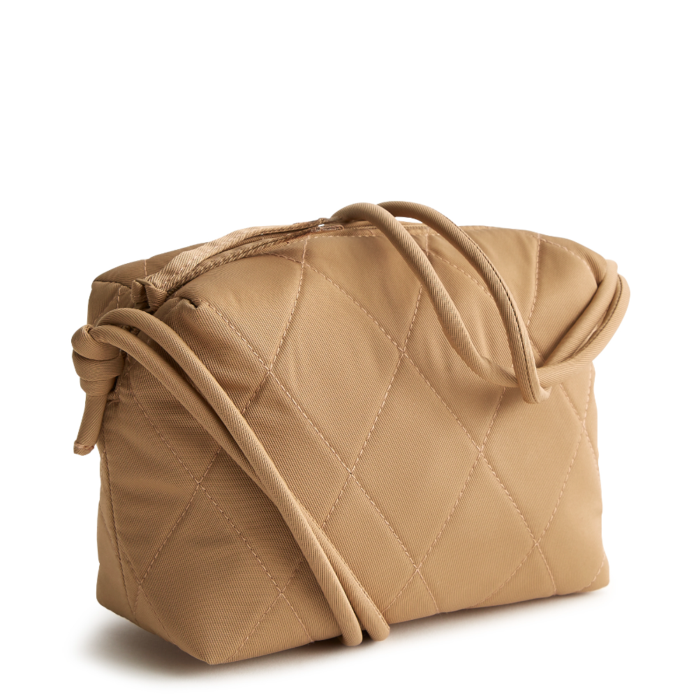 Designed for the minimalist at heart, this compact and versatile bag offers the perfect blend of style and functionality for those who prefer to travel light. The bag is shown in Vera Bradley's New Day Pattern, Tiger's Eye.