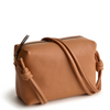 A leather crossbody purse in the color tan, designed by Vera Bradley from the Vera Bradley New Day launch. This crossbody is shown in the Vera Bradley pattern Roasted Pecan.