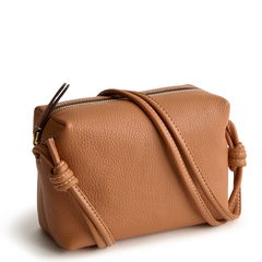 A leather crossbody purse in the color tan, designed by Vera Bradley from the Vera Bradley New Day launch. This crossbody is shown in the Vera Bradley pattern Roasted Pecan.