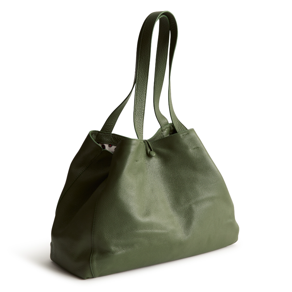 A green color tote bag from Vera Bradley New Day launch. The tote bag is made out of leather, and is shown in the Vera Bradley Pattern Bronze Green.