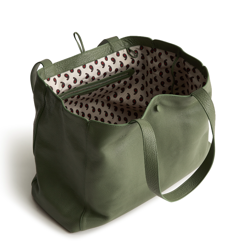 A green color tote bag from Vera Bradley New Day launch. The tote bag is made out of leather, and is shown in the Vera Bradley Pattern Bronze Green.