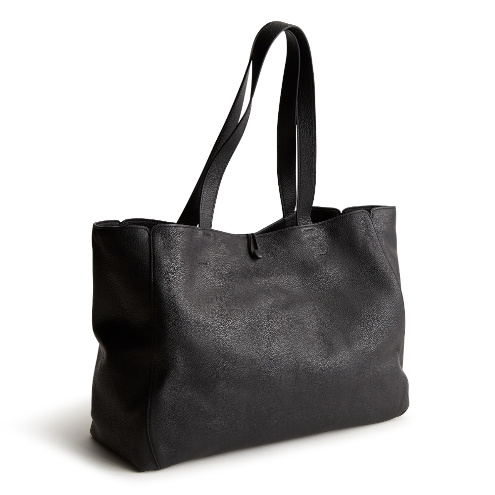 A black color tote bag from Vera Bradley New Day launch. The tote bag is made out of leather, and is shown in the Vera Bradley Pattern Moonless Night.