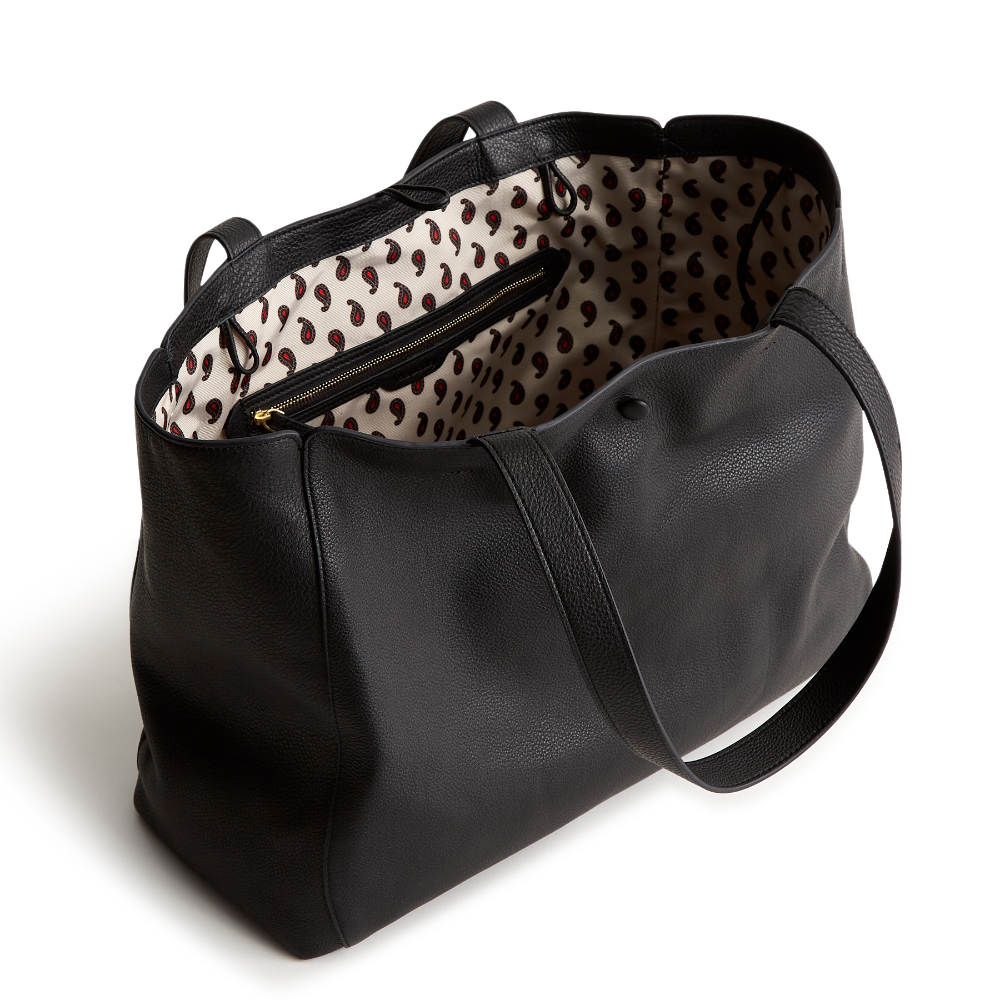 A black color tote bag from Vera Bradley New Day launch. The tote bag is made out of leather, and is shown in the Vera Bradley Pattern Moonless Night.