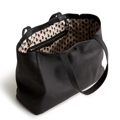 A black color tote bag from Vera Bradley New Day launch. The tote bag is made out of leather, and is shown in the Vera Bradley Pattern Moonless Night.