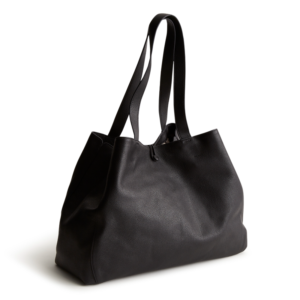A black color tote bag from Vera Bradley New Day launch. The tote bag is made out of leather, and is shown in the Vera Bradley Pattern Moonless Night.
