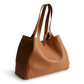A tan color tote bag from Vera Bradley New Day launch. The tote bag is made out of leather, and is shown in the Vera Bradley Pattern Roasted Pecan.