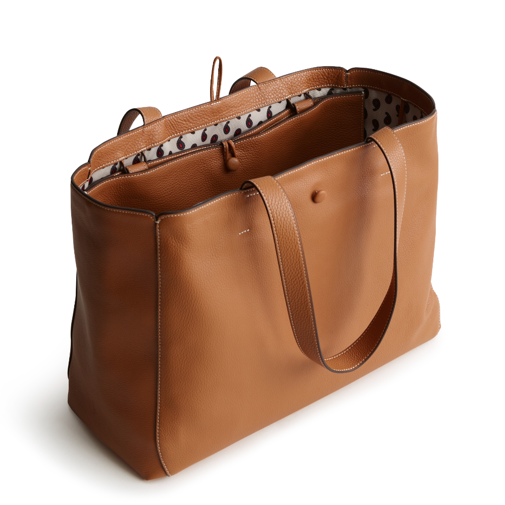 A tan color tote bag from Vera Bradley New Day launch. The tote bag is made out of leather, and is shown in the Vera Bradley Pattern Roasted Pecan.