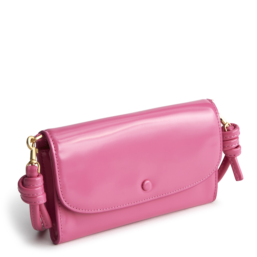 A Vera Bradley Wildwood Wallet Crossbody in Patent Faux Leather. Shown in the color pink.