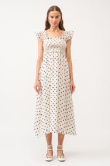 White midi dress with no sleeves, with black polkadots all over.