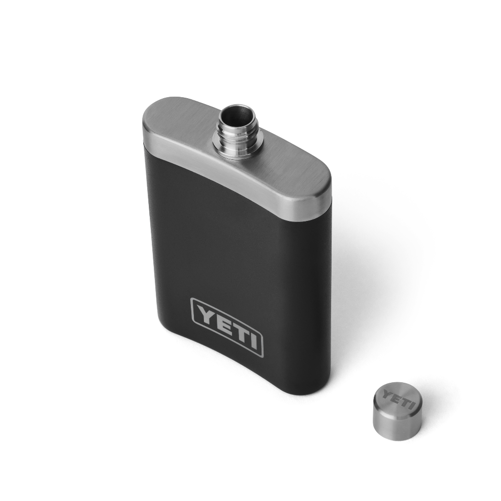 The top view of a black flask, with a silver top, with the cap off. A silver YETI logo is shown on the front of the flask.