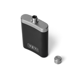 The top view of a black flask, with a silver top, with the cap off. A silver YETI logo is shown on the front of the flask.