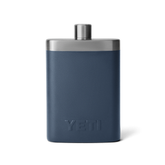 The back view of a navy blue flask with a silver top, and an all navy blue YETI logo on the back.