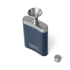 A navy blue flask, with a silver top, and silver funnel for easy pouring. Showing a silver YETI logo on the front.