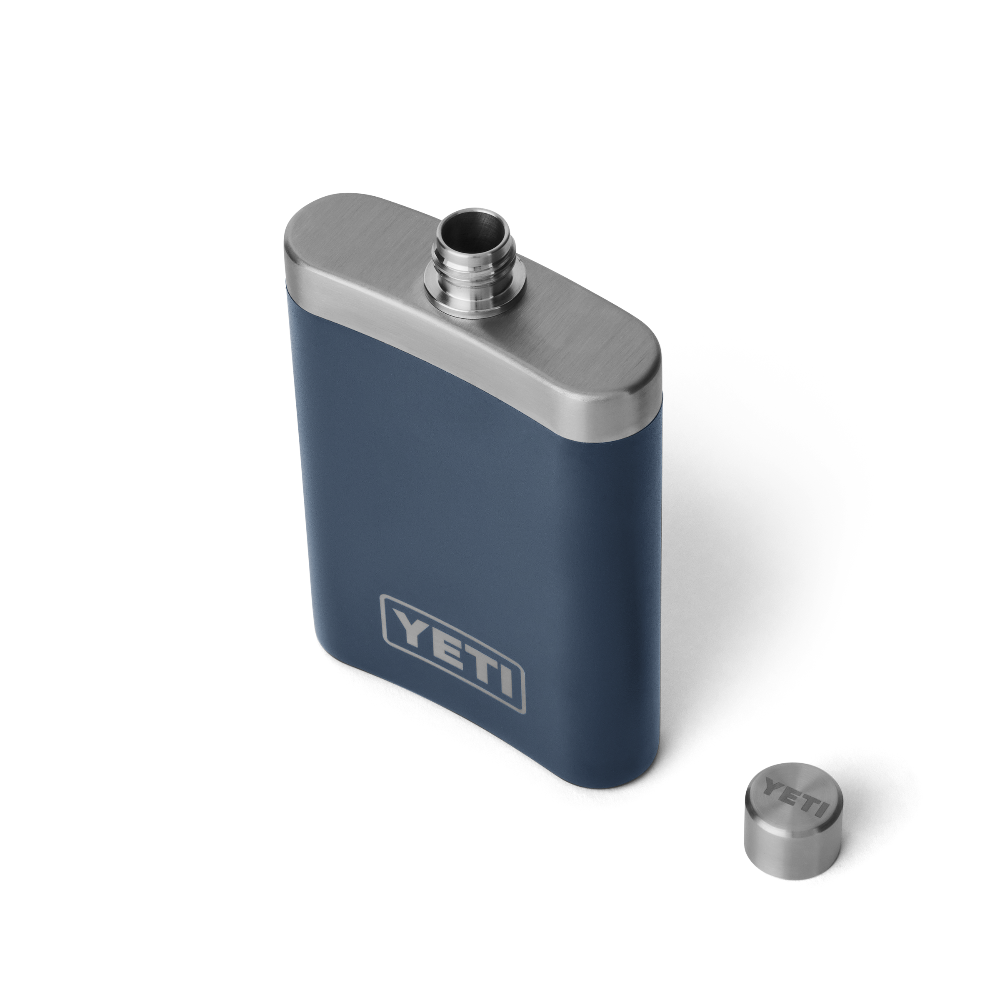 The top view of a navy blue flask, with a silver top, and a silver YETI logo on the front.