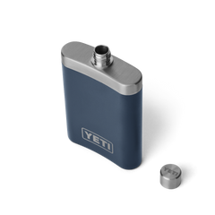 The top view of a navy blue flask, with a silver top, and a silver YETI logo on the front.