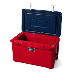 The limited edition 2024 Tundra 45 YETI Cooler with the lid open. The lid is the color navy blue, showing a YETI logo also in navy blue engraved into the interior of the lid. The base of the cooler is red, and the secure straps on the lid are white. The front of the cooler showcases a classic YETI logo.