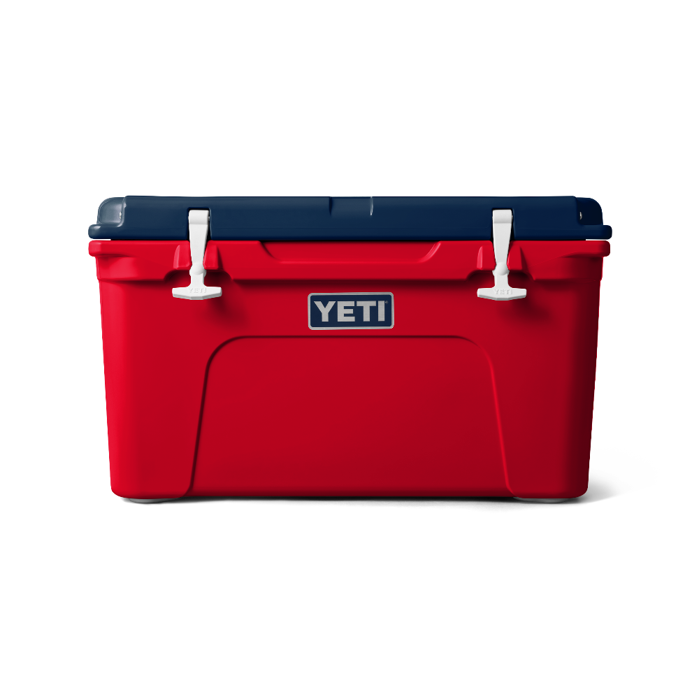 Front view of the limited edition 2024 YETI patriotic Tundra 45 Cooler. The top lid is navy blue, the base of the cooler is red, and the secure straps are white. The cooler shows a classic YETI brand logo on the front.