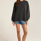 An all black modern weekender sweater from the brand Z Supply.