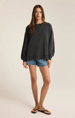 An all black modern weekender sweater from the brand Z Supply.