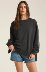 An all black modern weekender sweater from the brand Z Supply.