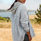 Z Supply model with black hair, wearing the All Day Knit Denim Jacket. The jacket features 6 front buttons, two chest pockets, and a collared top.