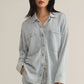 Z Supply model with black hair, wearing the All Day Knit Denim Jacket. The jacket features 6 front buttons, two chest pockets, and a collared top.