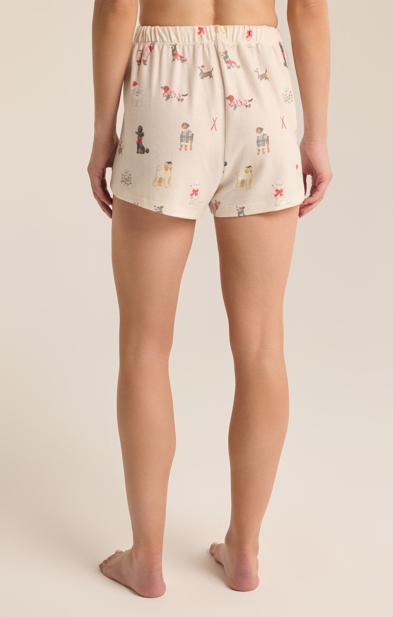 Lounge shorts with a draw string front. The shorts feature dogs dressed in Christmas outfits.