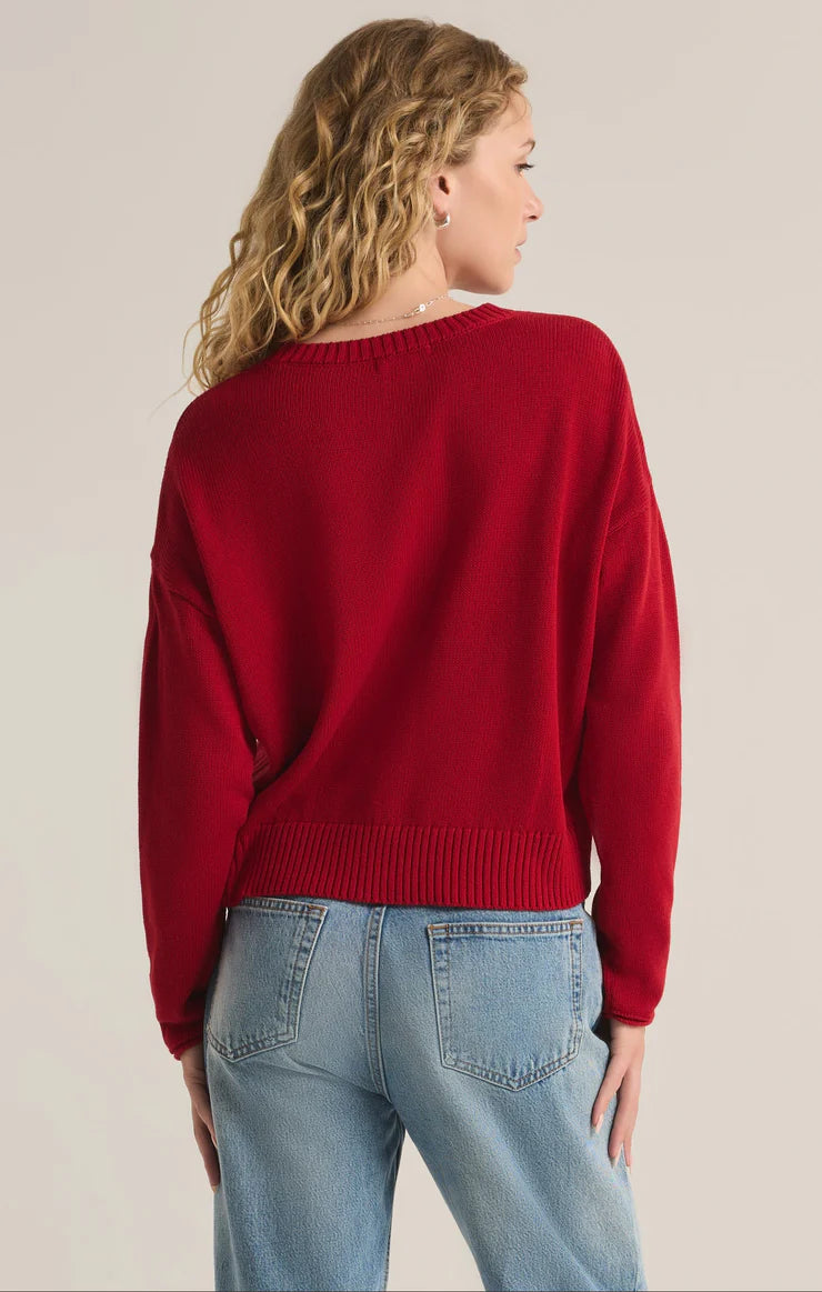 An all red knit sweater featuring the intarsia graphic "Merry." From the brand Z Supply.