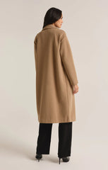 Tan colored mason coat from the brand Z-Supply. The coat has one button and it's length goes past the knees.