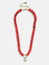 BaubleBar Janette Beaded Ring Necklace in red with glossy beads, a gold-tone collector ring and round crystal charm.