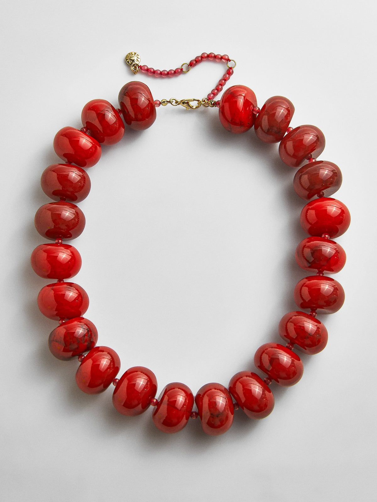 Full view of the BaubleBar Joan Semi-Precious Necklace in Red on a light background