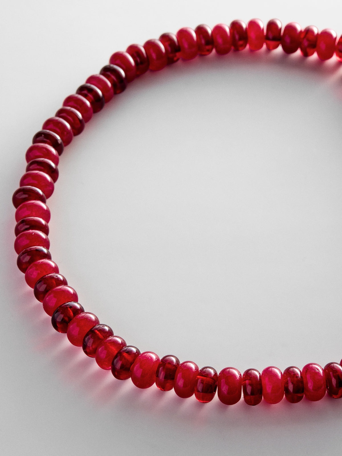 Close-up of the two-tone red beads on the BaubleBar Joyce necklace